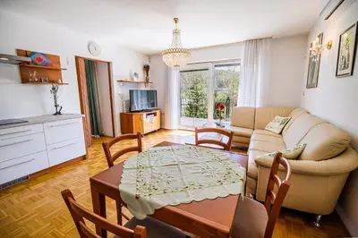 a living room with a couch and a table at Apartments Vila Lena at Aqualuna in Podčetrtek