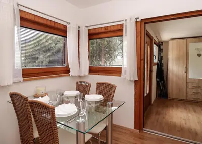 a dining room with a glass table and chairs at Aqualuna Olimia Vacation Home in Podčetrtek