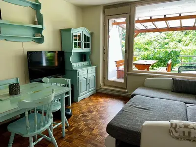 a living room with a couch and a table at Relax in nature Apartment in Bovec