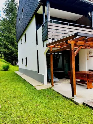 a white building with a picnic table next to it at Relax in nature Apartment in Bovec
