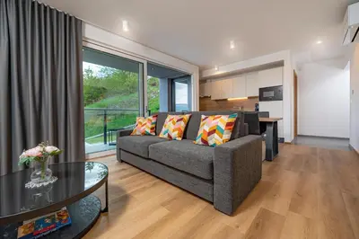 a living room with a couch and a table at Vila Katarina - Lake View Apartments in Bled