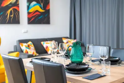 a table with wine glasses and a vase on it at Vila Katarina - Lake View Apartments in Bled