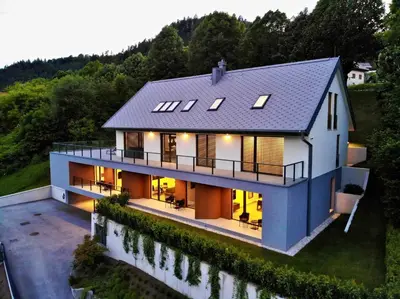 an aerial view of a house with lights at Vila Katarina - Lake View Apartments in Bled