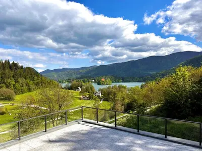 a balcony with a view of a lake and mountains at Vila Katarina - Lake View Apartments in Bled