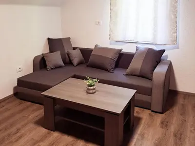 a living room with a couch and a coffee table at Tourist Farm Pr' Maretč in Bohinjska Bistrica