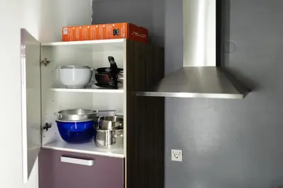 a kitchen with a shelf with food items on it at Svarun apartment in Bovec