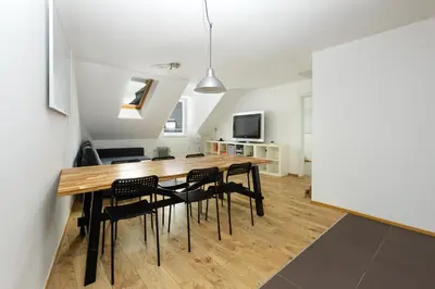 a dining room with a wooden table and chairs at Svarun apartment in Bovec