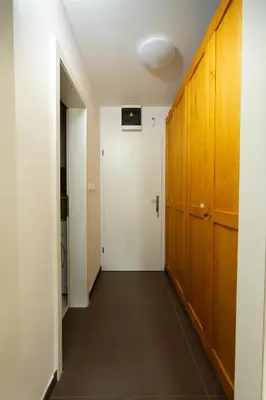 a hallway with a door and a room with a hallway at Svarun apartment in Bovec
