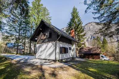 a small house in the middle of a field at Holiday Home Kozorog in Bohinj