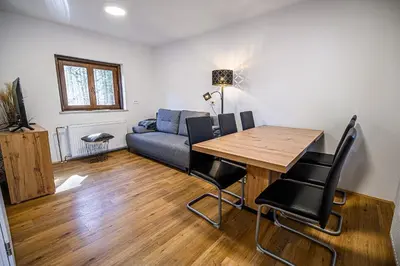 a living room with a table and a couch at Holiday Home Kozorog in Bohinj