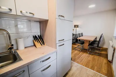 a kitchen with a sink and a table at Holiday Home Kozorog in Bohinj