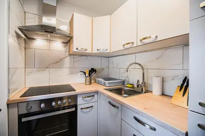 a kitchen with a sink and a stove at Holiday Home Kozorog in Bohinj