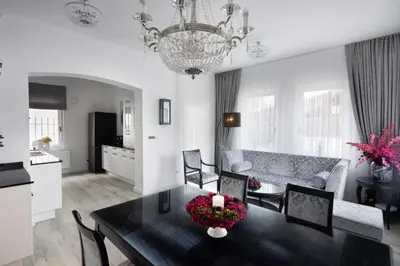 a dining room and living room with a dining table at Vila Mignon in Bled