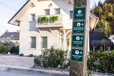 a pole with signs on it in front of a house at Vila Mignon in Bled