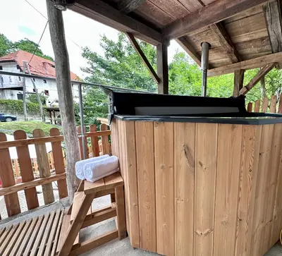 a hot tub in a wooden pergola on a deck at Bajta Kroparica in Kropa