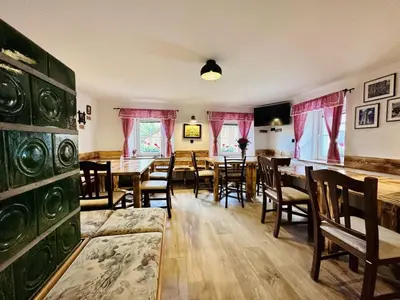 a dining room with wooden tables and chairs at Bajta Kroparica in Kropa
