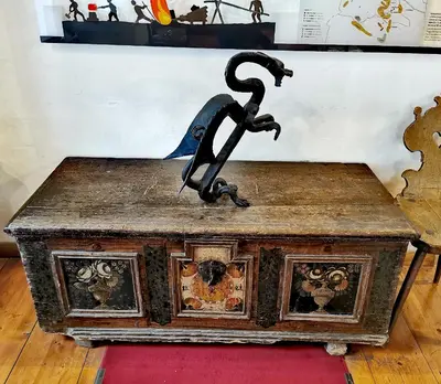 an old wooden table with a statue on top of it at Bajta Kroparica in Kropa