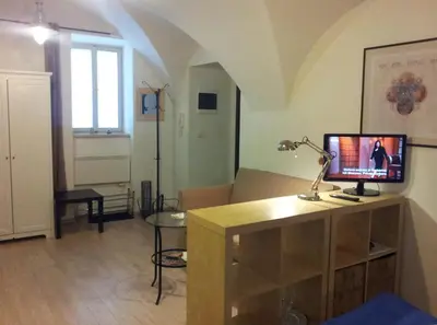 a living room with a desk with a computer on it at Studio Ian in Ljubljana