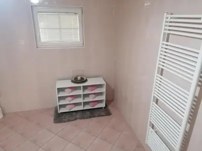 a white room with a cabinet with pink hearts at Apartma Sandi in Šentilj