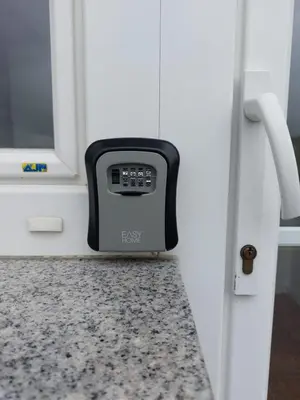 a close up of a kitchen door with a clock on a counter at Apartma Sandi in Šentilj