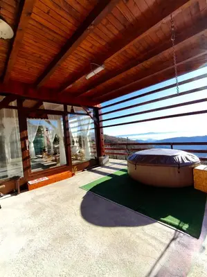 a room with a large window with a large ottoman at Apartma na KOZOLCU in Dobovec