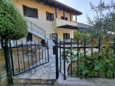 a fence in front of a house at Hiša Rožmarin in Osp