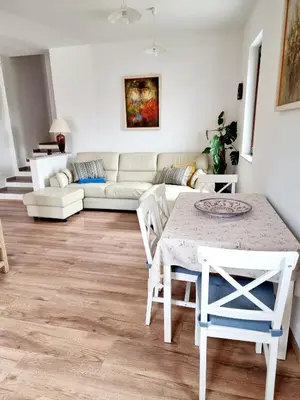 a living room with a table and a couch at Hiša Rožmarin in Osp