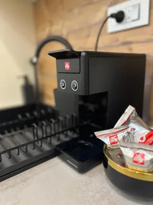 a coffee maker sitting on a counter next to a plate of food at City Apartment Chiara in Maribor