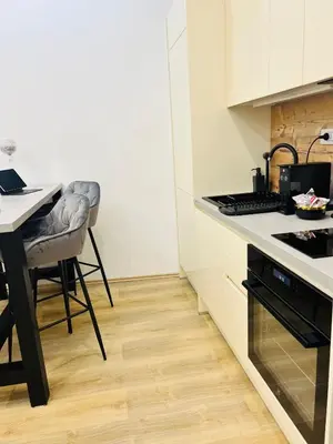a kitchen with a table and a counter top at City Apartment Chiara in Maribor