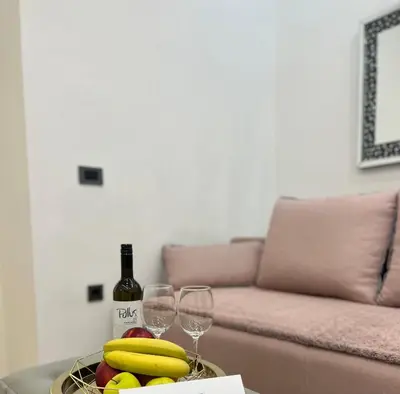 a table with a bowl of bananas and wine glasses at City Apartment Chiara in Maribor