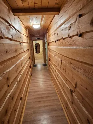 a hallway in a log cabin with wooden walls at Koča na Taležu in Bled