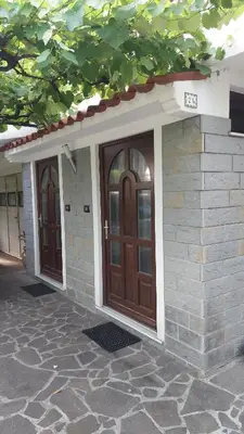 a house with two doors on the side of it at Apartma Rižana in Dekani