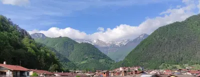 a view of a mountain valley with houses and mountains at Apartma ALTA in Tolmin