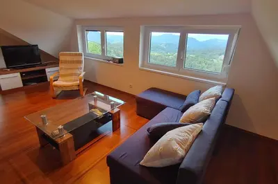 a living room with a couch and a table at Vikend hiša Vrhe in Senovo