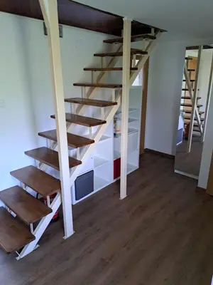 a staircase in a room with wooden floors at Vikend hiša Vrhe in Senovo