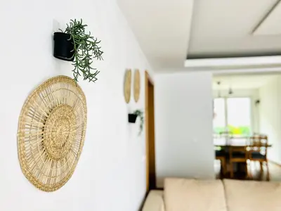 a wicker basket hanging on a wall next to a couch at Sunny app in Ljubljana
