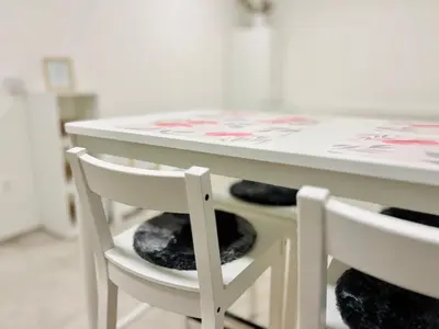 a white table with two white chairs under it at Sunny app in Ljubljana
