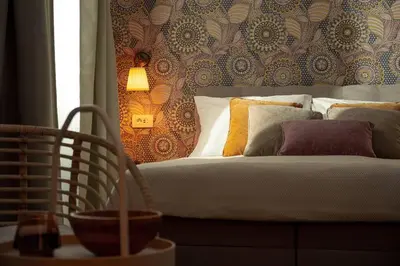 a bedroom with a bed with pillows on it at New Cute Studioapartment in Ljubljana + Free bikes in Ljubljana