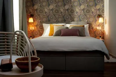 a bedroom with a bed and a wall at New Cute Studioapartment in Ljubljana + Free bikes in Ljubljana