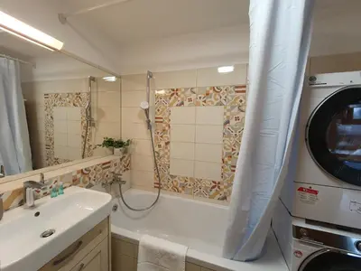 a bathroom with a sink and a washing machine at Apartment Zala with free parking Tour As Ljubljana in Ljubljana