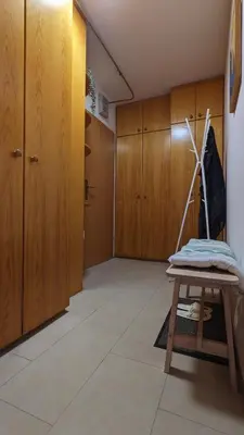 a room with wooden cabinets and a table in a room at Apartment Zala with free parking Tour As Ljubljana in Ljubljana