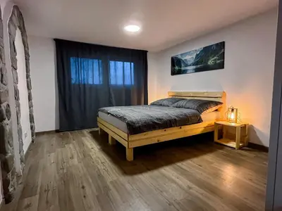 a bedroom with a bed and a window at Apartment Neli in Rečica ob Savinji