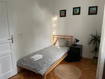 a small bedroom with a bed in a room at Pirc apartment on Dunajska street in Ljubljana