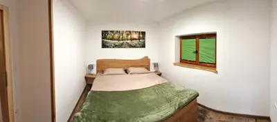 a small bedroom with a bed and a window at Bled Straza House in Bled