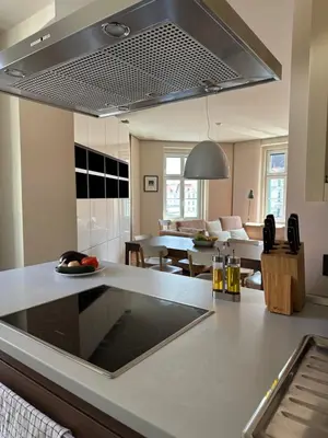 a kitchen and living room with a counter top at Triple Bridge Ljubljana in Ljubljana