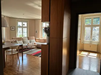 a living room with a couch and a table at Triple Bridge Ljubljana in Ljubljana