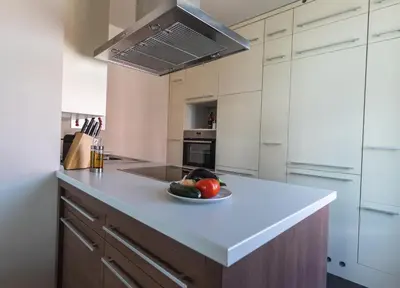 a kitchen with a bowl of fruit on a counter at Triple Bridge Ljubljana in Ljubljana