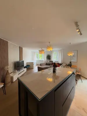 a large kitchen and living room with a large island at Luxury Residence Res in Ljubljana