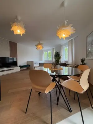 a living room with a dining room table and chairs at Luxury Residence Res in Ljubljana