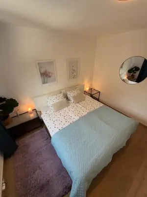 a bedroom with a bed and a mirror on the wall at Luxury Residence Res in Ljubljana
